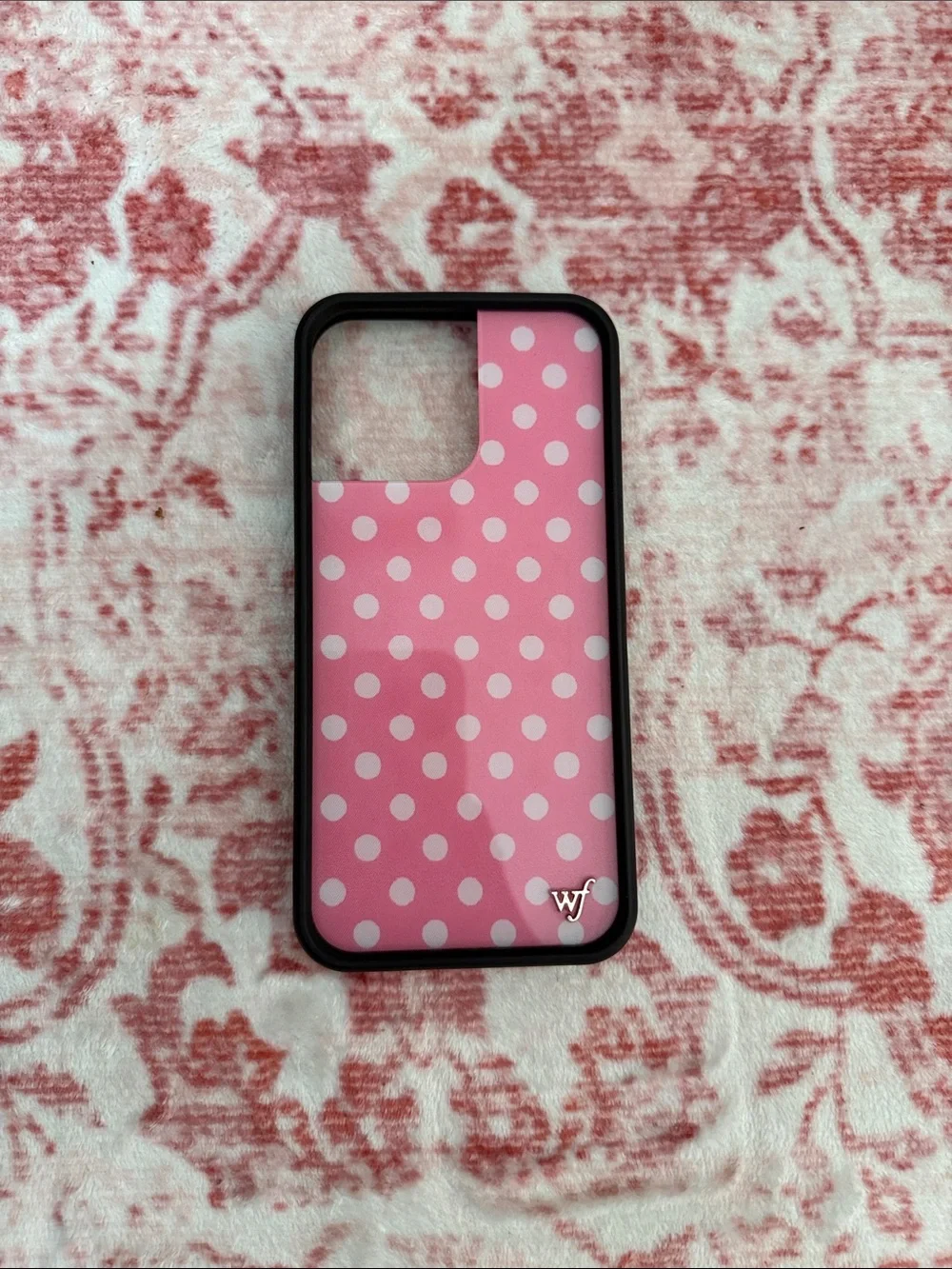 Wildflower iPhone case featuring a classic pink and white polka dot design.